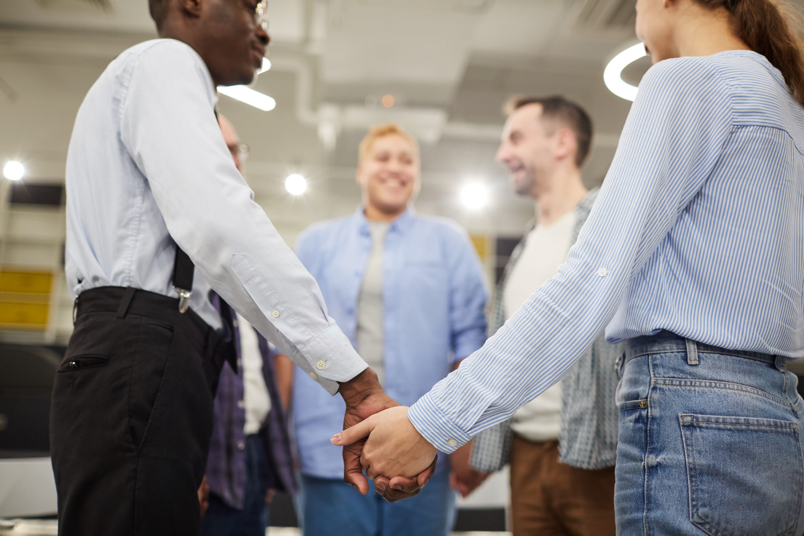 People Holding Hands in Circle people holding hands symbolizing customer love and how to love your clients back