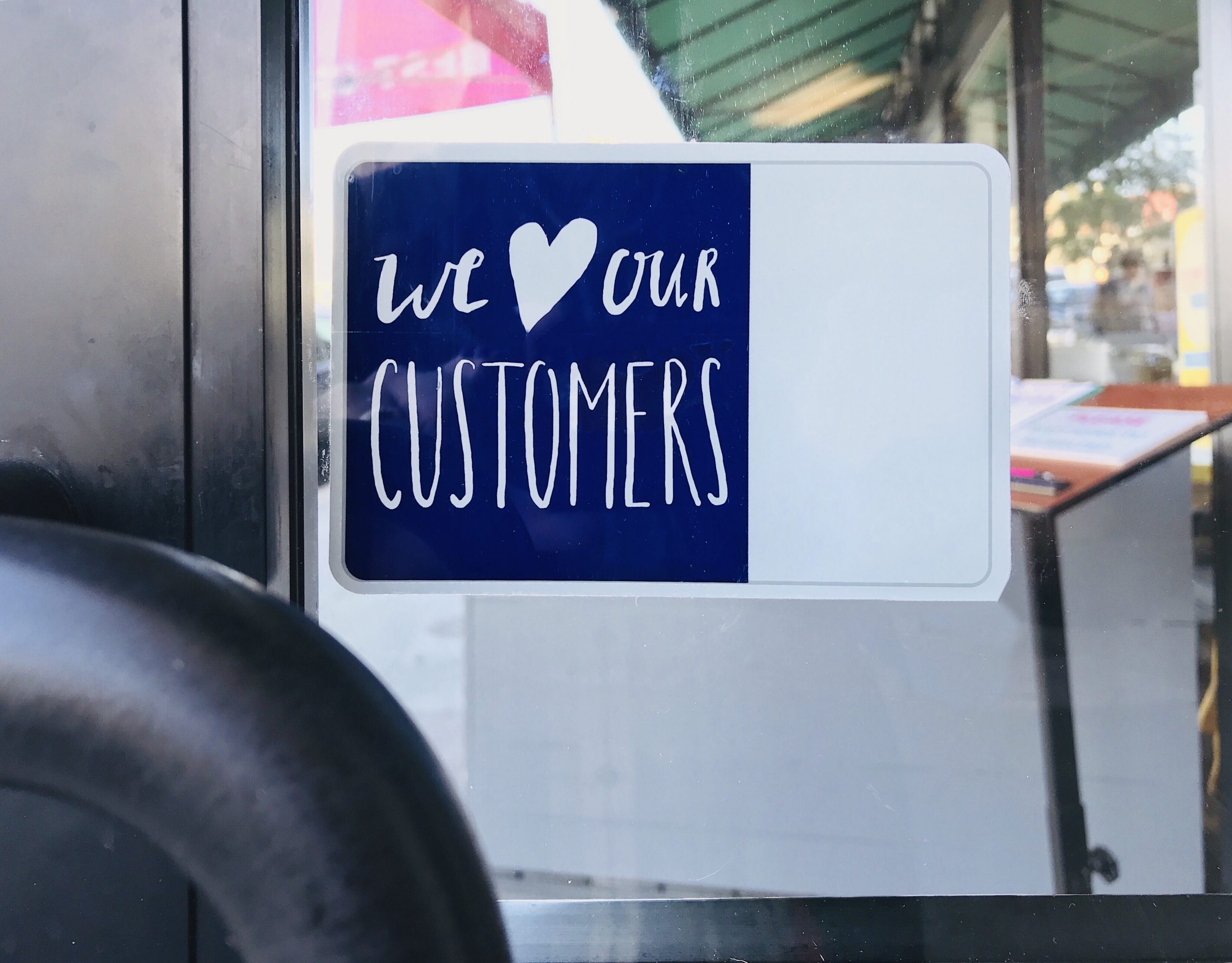 we-love-our-customers-sign-on-a-door-2021-08-29-01-13-40-utc image of a business sign that shows Customer Love and how to love your clients back