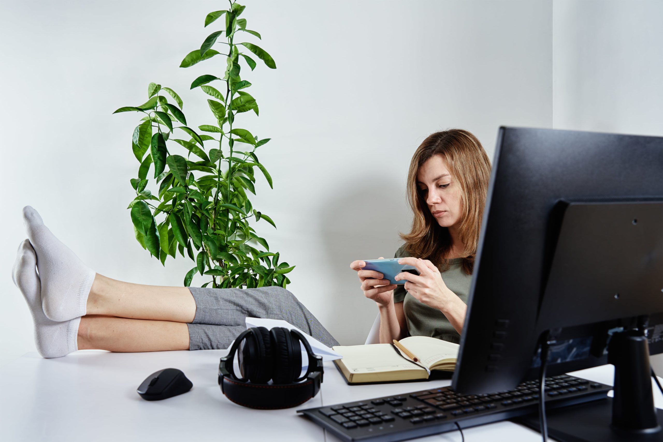 woman-use-smartphone-while-working-online-2022-04-14-16-20-33-utc-min
