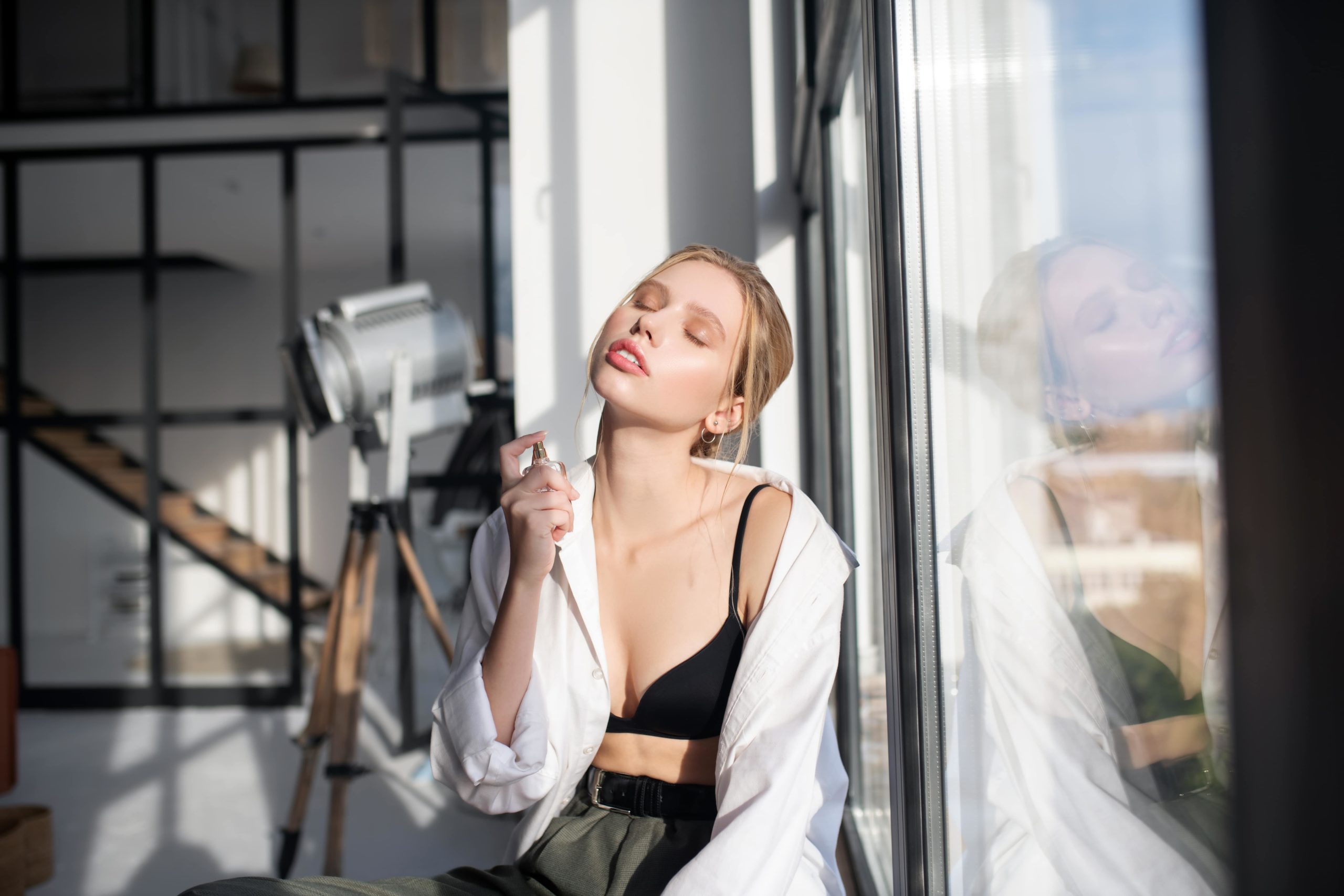 woman putting on perfume demonstrating emotions in a scalable marketing plan -min